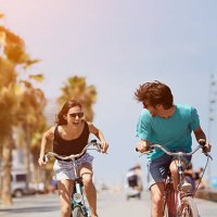 woman chasing man while riding bicycle - travel stock pictures, royalty-free photos & images