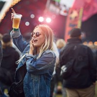 woman cheering with beer at concert - concert stock pictures, royalty-free photos & images