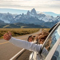 woman chilling and holding her hand outside of window while on the highway to the dramatic mountain range with fitz roy mountain in the middle - a road to el chalten from el calafate, argentina - travel photos et images de c