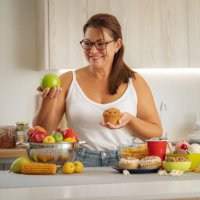 woman chooses healthy food rather than junk food - junk food stock pictures, royalty-free photos & images