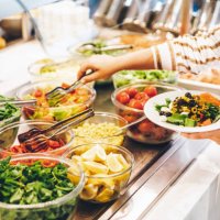 woman choosing food for breakfast at hotel restaurant. woman taking food from a buffet line. - food stock pictures, royalty-free photos & images