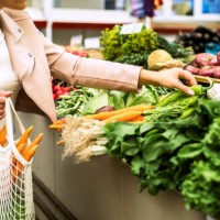 woman choosing greenery and vegetables at farmer market and using reusable eco bag. - food stock pictures, royalty-free photos & images