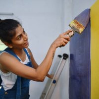 woman coloring interiors of her workshop - home decoration stock pictures, royalty-free photos & images