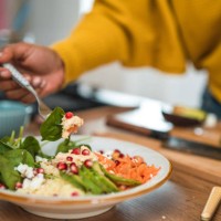 woman creating a vibrant salad for her next food vlog - food stock pictures, royalty-free photos & images