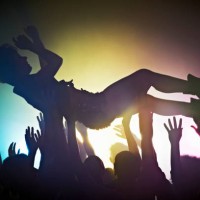 woman crowd surfing - concert stock-fotos und bilder