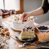 woman cut a piece of cake for the birthday celebrant - home decoration stock pictures, royalty-free photos & images