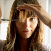 woman cutting hair with scissors, close-up - hairstyle stockfoto's en -beelden