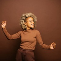 woman dancing against a brown background - fashion stock pictures, royalty-free photos & images