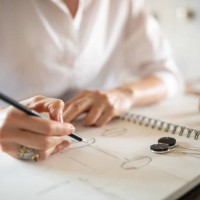 woman designing jewelry in her atelier - fashion stock pictures, royalty-free photos & images