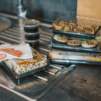 woman disinfecting takeaway sushi boxes - junk food stock pictures, royalty-free photos & images