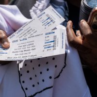 Woman displays her tickets as hundreds of people gather at Washington Square Park for a chance to see Australian rapper and singer The Kid LAROI...