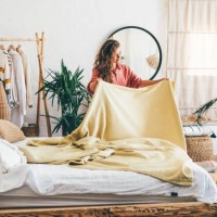 woman doing her morning routine, arranging pillows and making up bed at home. - home decoration stock pictures, royalty-free photos & images