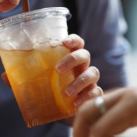 woman drink fresh lemon tea close up view of ice cubes in cold brewed iced tea in clear glass, drink beverage - junk food stock pictures, royalty-free photos & images
