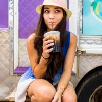 woman drinking ice coffee near food cart - junk food stock pictures, royalty-free photos & images