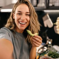 woman eating avocado and taking selfie - food stock pictures, royalty-free photos & images