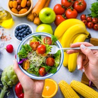 woman eating fresh rainbow colored salad. multicolored fruits and vegetables background. healthy eating and dieting concept - food stock pictures, royalty-free photos & images