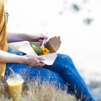 woman eating healthy food from plastic free lunch box in countryside, close up. - junk food stock pictures, royalty-free photos & images
