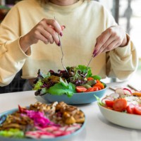 woman eating healthy salad - food stock pictures, royalty-free photos & images