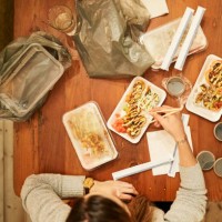 woman eating sushi with chopsticks - junk food stock pictures, royalty-free photos & images