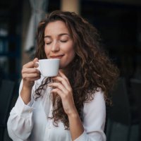 woman enjoying cappuccino in a cafe - coffee stock pictures, royalty-free photos & images