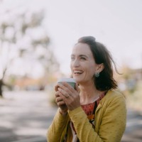 woman enjoying takeaway coffee in suburb - junk food stock pictures, royalty-free photos & images