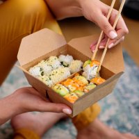 woman enjoying takeaway sushi at home - junk food stock pictures, royalty-free photos & images