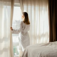 woman enjoys magnificent view from hotel window - travel stock pictures, royalty-free photos & images