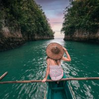 woman exploring a river on small boat at sunset, philippines - travel stock pictures, royalty-free photos & images