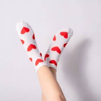 woman feets in warm socks with a hearts print on white background - fashion stock pictures, royalty-free photos & images