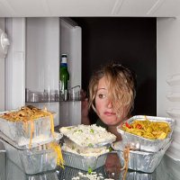 woman finds take-out food containers in fridge. - junk food stock pictures, royalty-free photos & images