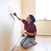 woman finishing wall while renovating home - home decoration stock pictures, royalty-free photos & images