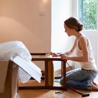 woman fixing piece of furniture - home decoration stock pictures, royalty-free photos & images
