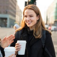 woman friends having coffee and talking on the city street - junk food stock pictures, royalty-free photos & images