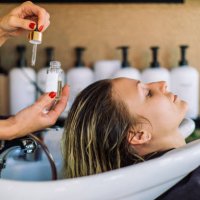 woman getting her hair washed in hair salon - hairstyle stock pictures, royalty-free photos & images