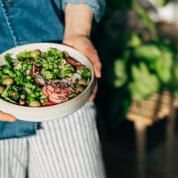 woman hands eating vegan salad of baked vegetables, avocado, tofu and buckwheat buddha bowl, top view. plant based food concept. - food stock pictures, royalty-free photos & images