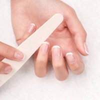 woman hands in a nail salon receiving a manicure. - nails art stock pictures, royalty-free photos & images