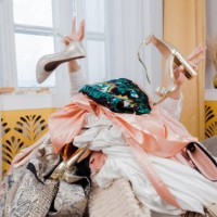 woman hands out of a pile of clothes and accessories on the floor. too much shopping. shopaholic girl. shopping addiction concept. - fashion stock pictures, royalty-free photos & images