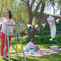 woman hanging bunting outdoors - garden decoration stock pictures, royalty-free photos & images