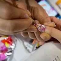 Woman has her choosen anime character painted onto her fingernails at Ita Color's Yellow nail salon on February 27, 2014 in Akihabara district,...