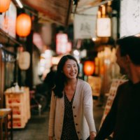 woman having a good time with her boyfriend in tokyo at night - travel stock pictures, royalty-free photos & images