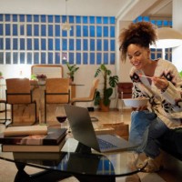 woman having dinner and watching movie at home - junk food stock pictures, royalty-free photos & images
