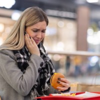 woman having toothache from burger - junk food stock pictures, royalty-free photos & images