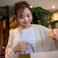 woman holding a paper bag in cafe - junk food stock pictures, royalty-free photos & images