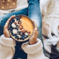woman holding a pumpkin smoothie bowl - food stock pictures, royalty-free photos & images