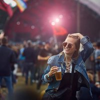 woman holding beer and laughing at concert - concert stock pictures, royalty-free photos & images
