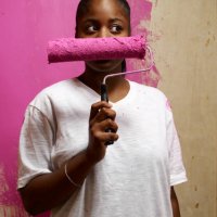 woman holding paint roller across face - home decoration stock pictures, royalty-free photos & images