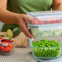 woman holding plastic airtight food containers filled with vegetables ready for be stored in the refrigerator - food stock pictures, royalty-free photos & images