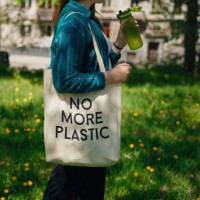 woman holding reusable cotton zero waste bag with text no more plastic. outdoors portrait in sunny day. eco friendly bags concept. - food stock pictures, royalty-free photos & images