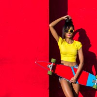 woman holding scateboard - fashion stock pictures, royalty-free photos & images