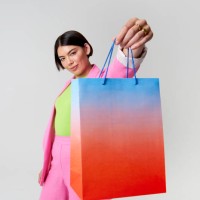 woman holding shopping bag toward camera - fashion stock pictures, royalty-free photos & images
